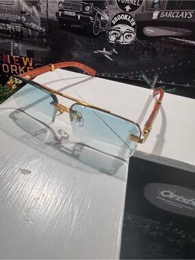 Gold Frame Blue Lens Rimless Sunglasses with Red Temple Accents